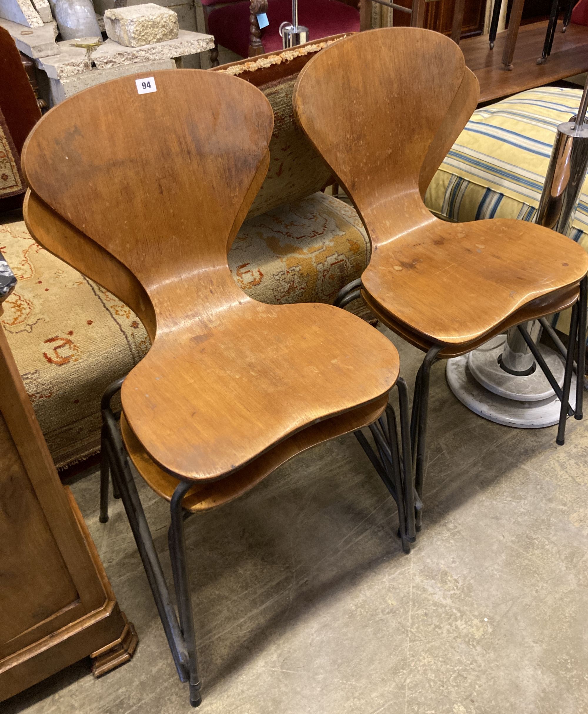 A set of four Jacobsen style bent-ply and tubular metal stacking dining chairs, width 44cm, depth 42cm, height 86cm